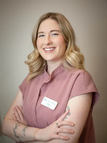 a woman with arms crossed smiling - avery